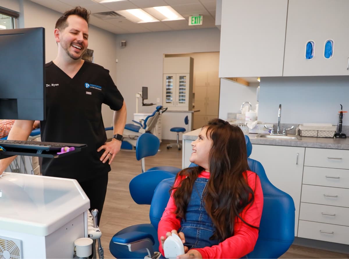 Dr. Pendleton and young patient laughing during visit