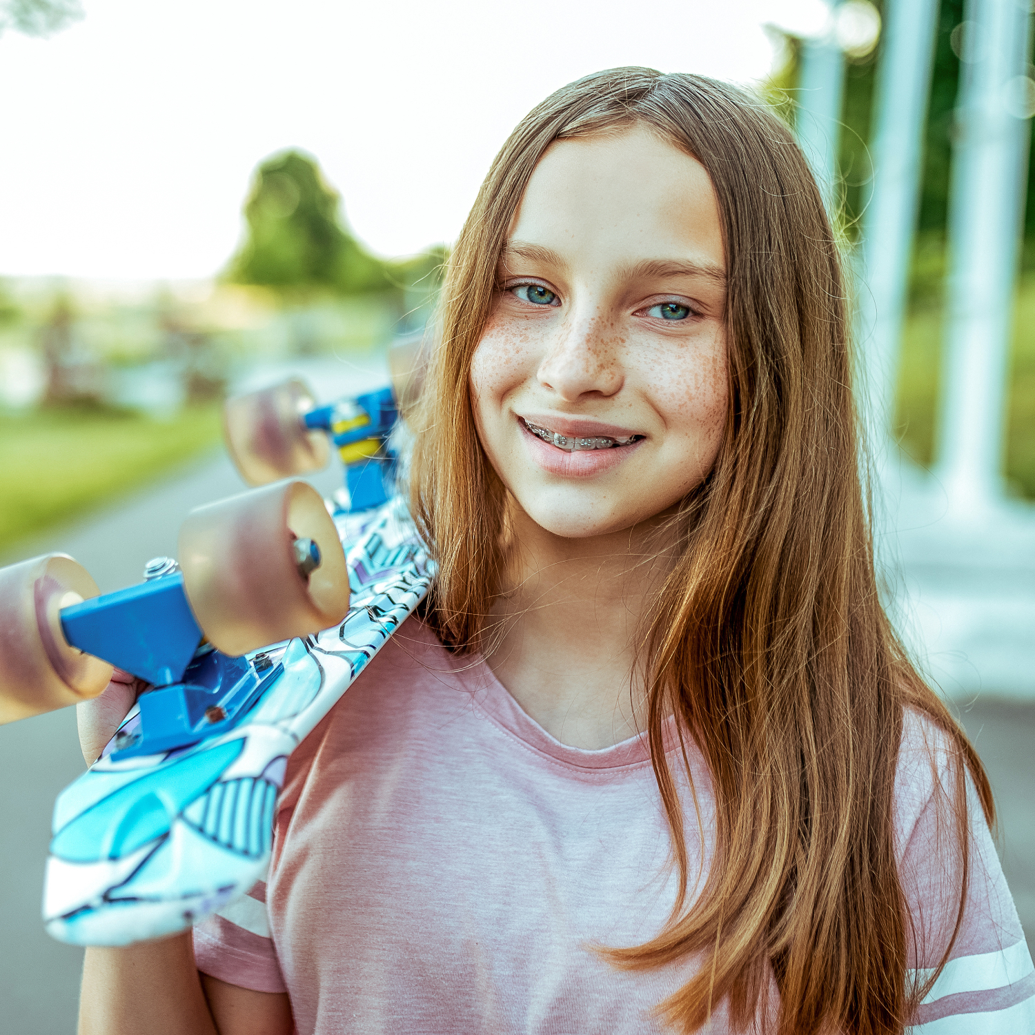 teen Pendleton Orthodontics patient holding skateboard