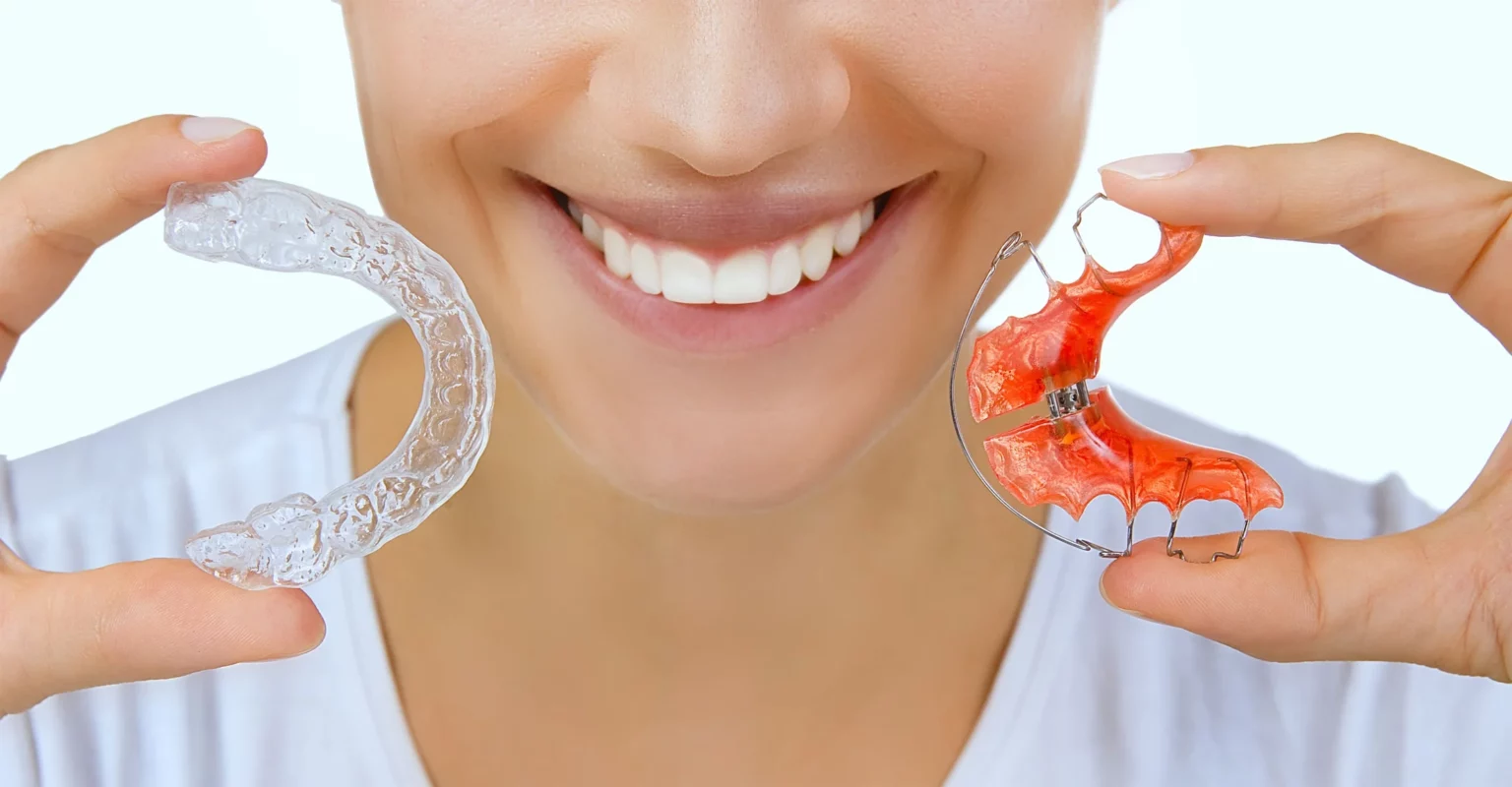 Woman holding two retainers