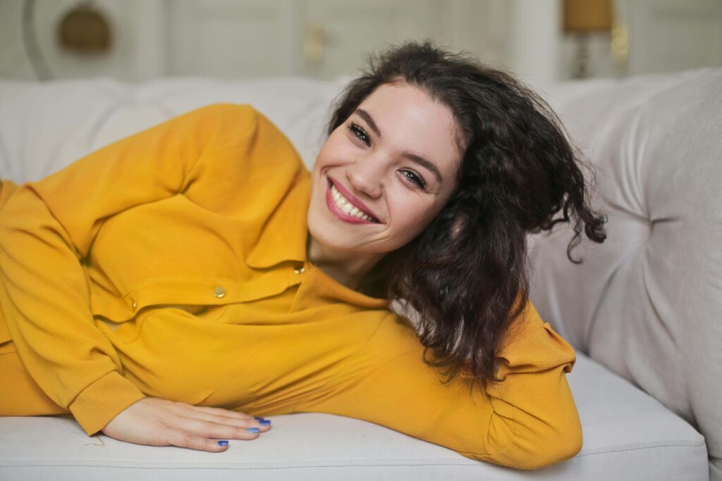 woman smiling on couch